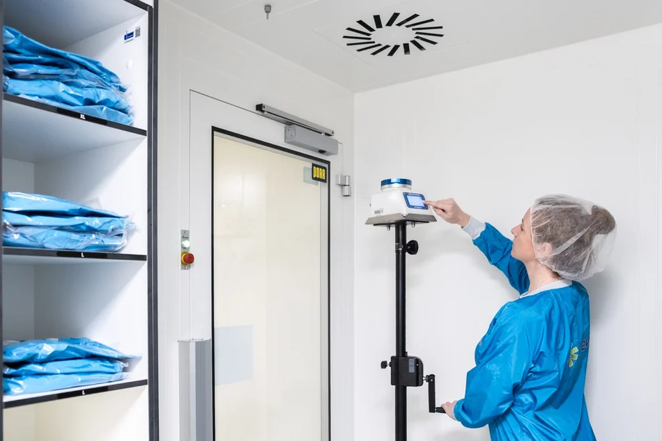 Studentin arbeitet in der Reinraumschleuse mit Messgerät (Luftkeimsammler).